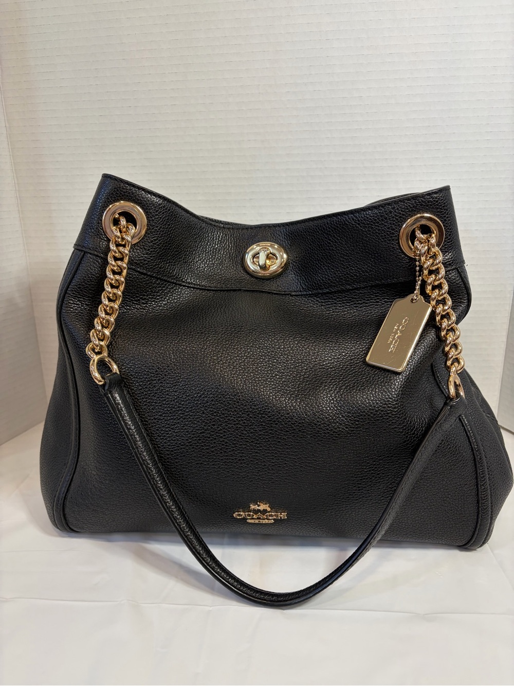 Coach Edie Turnlock Black Pebbled Leather Shoulder Bag with Gold Chain.